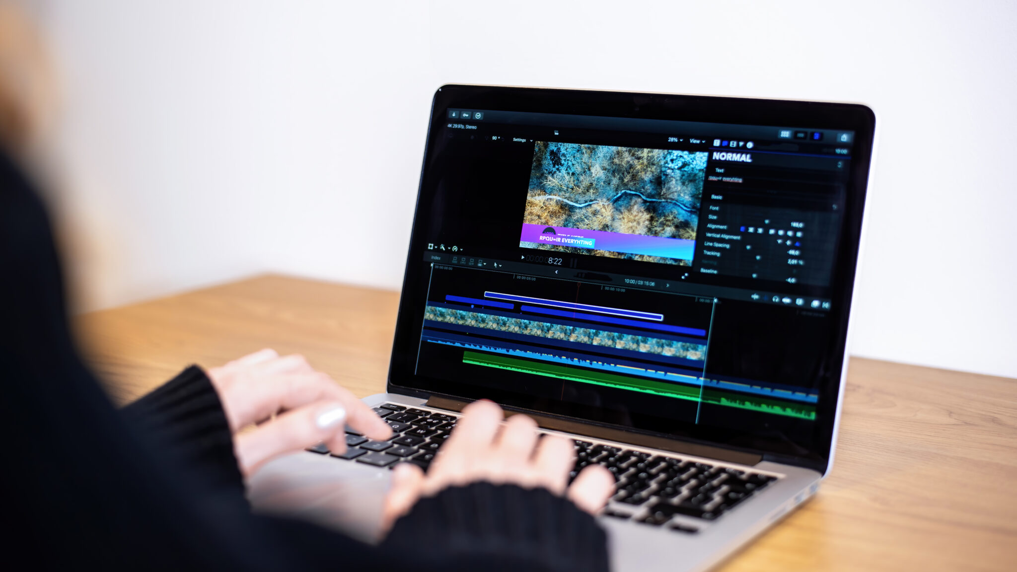 Young content creator girl editing video on her laptop. Working from home